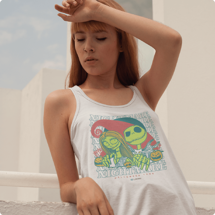 young lady wearing a white racer back tank top with 2 skeleton characters and a 'Nightmare' text