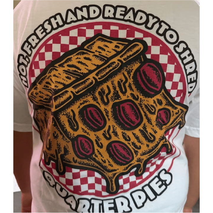 Rear view of a white youth t-shirt with a graphic of a pizza quarter pipe and hot fresh and ready to shred text.