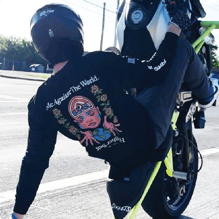 rear view of footbrake jake doing a wheelie in our black higher self shirt.