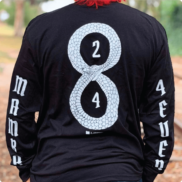 Rear view of a man wearing a kobe inspired 'Mamba forever' 8 24 black long sleeved shirt