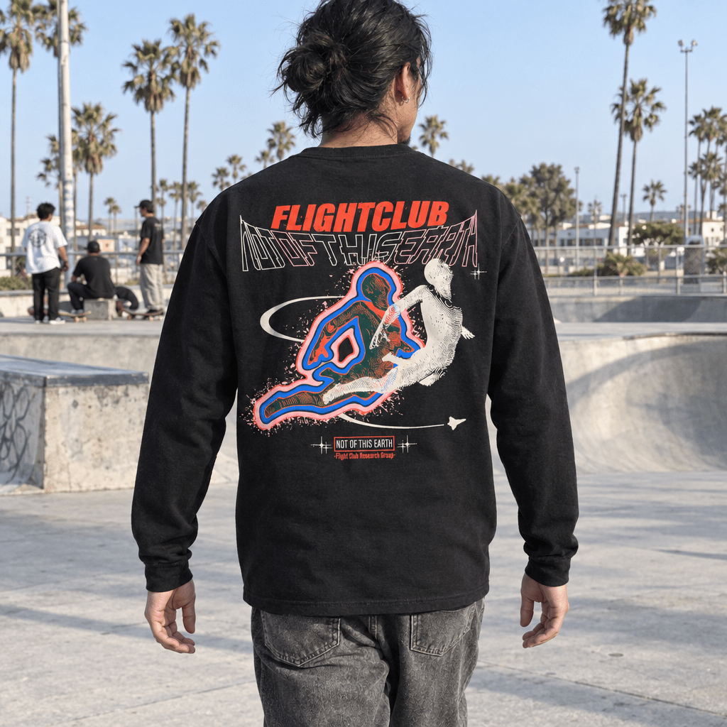 Not of This Earth black long sleeve at a skate park, candid rear view