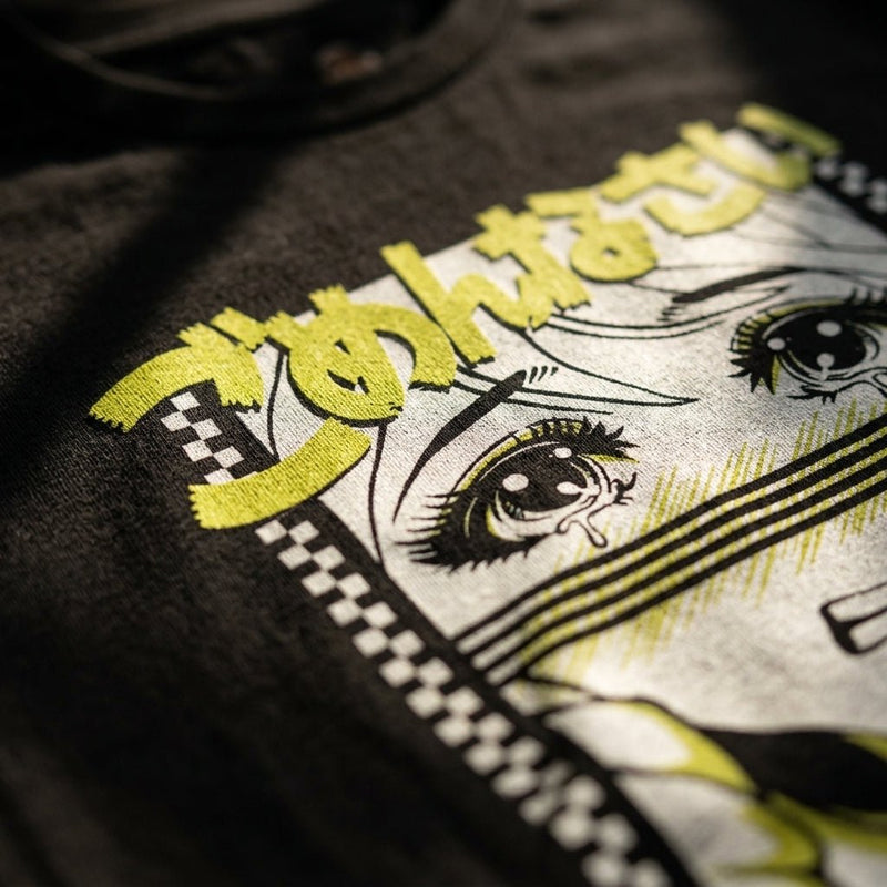 close up print detail of chi hom's it'll be ok t-shirt on a black garment