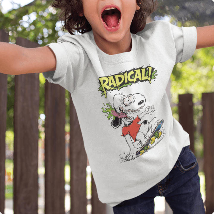 Child wearing a white t-shirt with a Snoopy graphic and the word 'RADICAL!' at an outdoor playground.